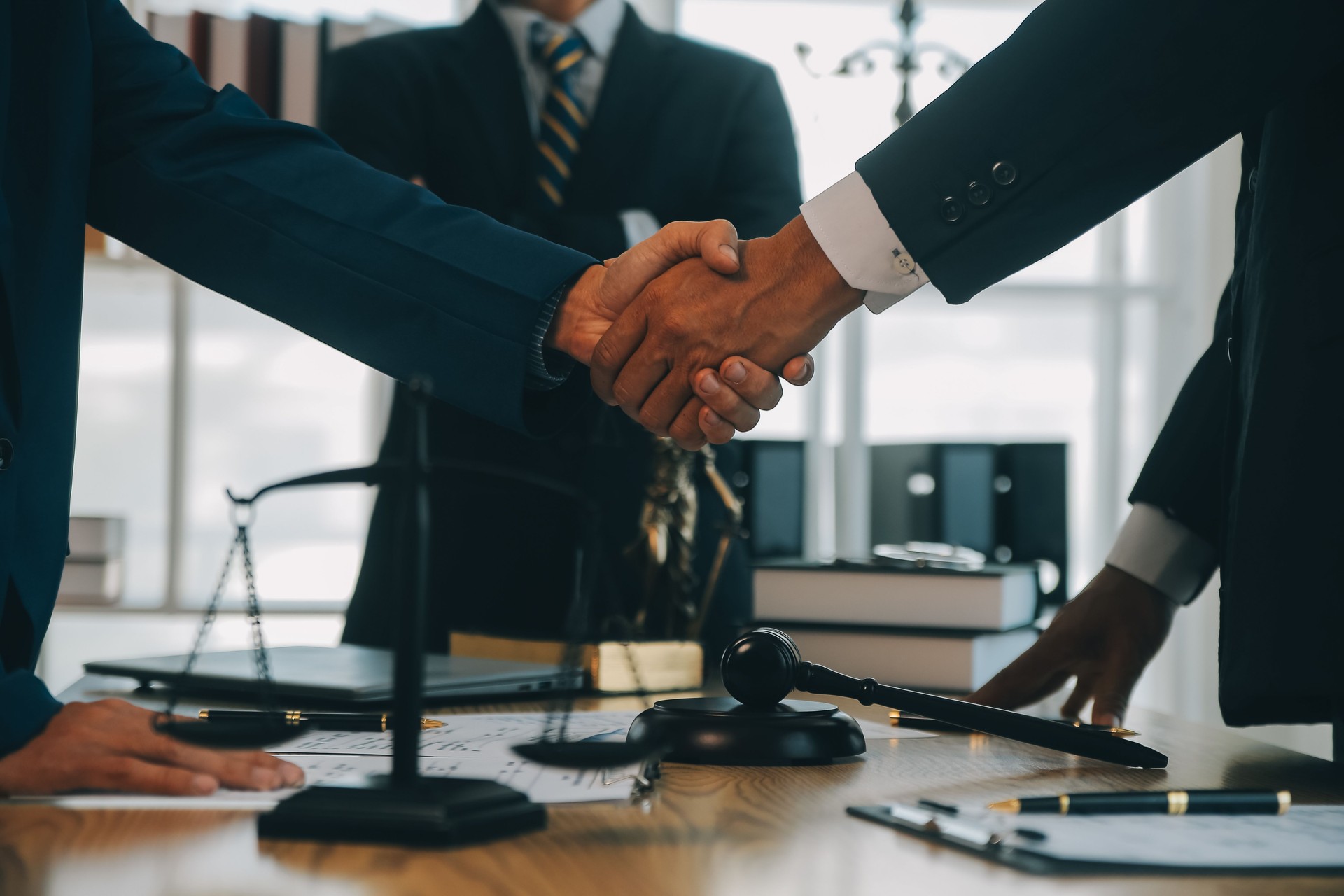 Consultation and conference of Male lawyers and professional businesswoman working and discussion having at law firm in office. Concepts of law, Judge gavel with scales of justice.